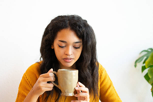istock Young latin woman drinking a warm beverage at home 2205666847