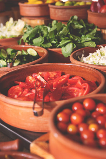 istock Delicious buffet table with Fresh and Vibrant Organic Vegetables in Rustic Clay Bowls and greens, featuring variety of healthy and colorful plant-based dishes for vegetarian or vegan meal 2205667304
