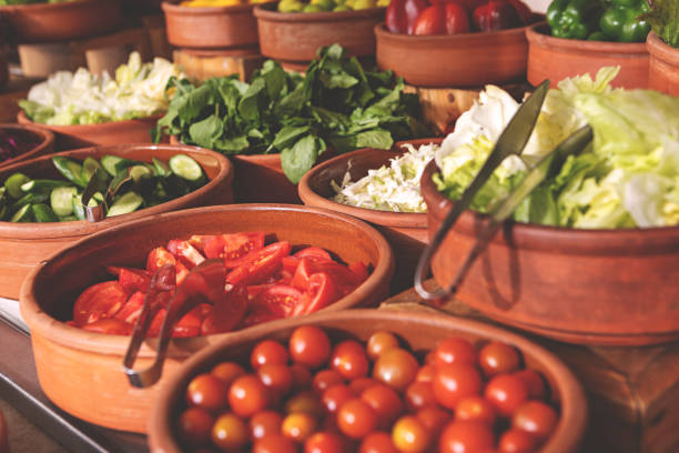 istock Delicious buffet table with Fresh and Vibrant Organic Vegetables in Rustic Clay Bowls and greens, featuring variety of healthy and colorful plant-based dishes for vegetarian or vegan meal 2205667305