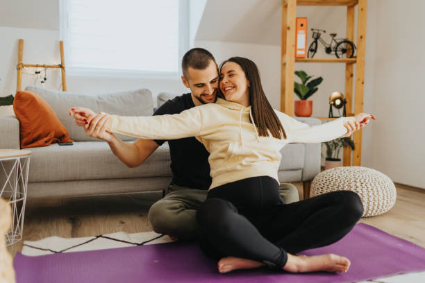 istock Pregnant woman doing exercises with her husband at home 2205669083