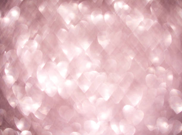 istock Soft pink glowing heart-shaped bokeh lights with a romantic dreamy ambiance 2205669107