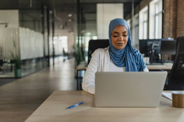 istock Muslim Woman Focused on Laptop Work 2205672747