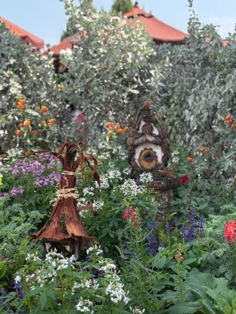Small angel figure in the garden with daisies