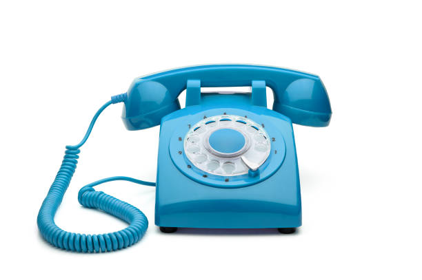 Old, blue rotary telephone isolated on white