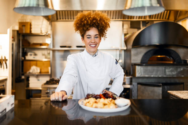 istock Smiling Woman Chef Showcasing Her Culinary Creation 2205674973