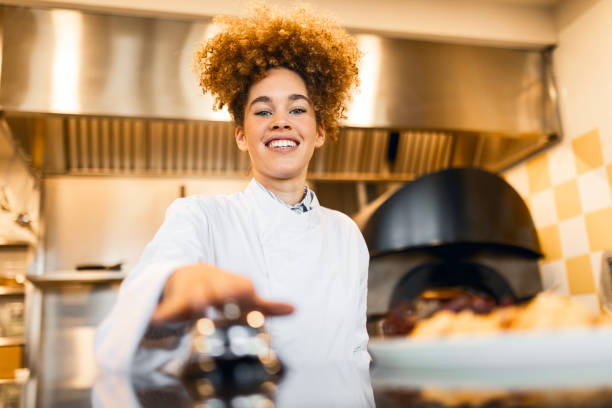 istock Professional Cook Using a Restaurant Bell to Serve a Dish 2205675034