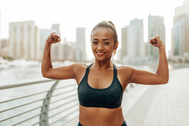 istock woman showing her muscle 2205675234