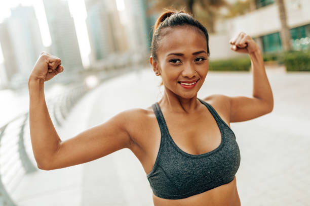 istock woman showing her muscle 2205675258