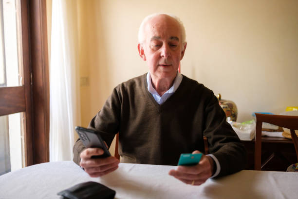 istock Senior man making online payment using smartphone and credit card at home 2205677430