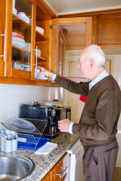 istock Senior man preparing coffee in his kitchen 2205678117