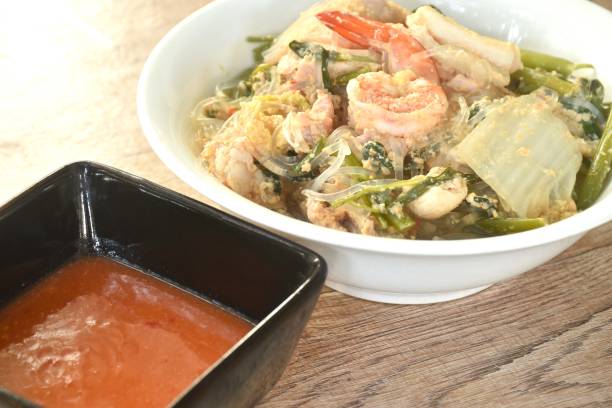 boiled sukiyaki seafood chicken and pork meat couple crispy pickled squid and shrimp with vegetable in soup dipping sauce