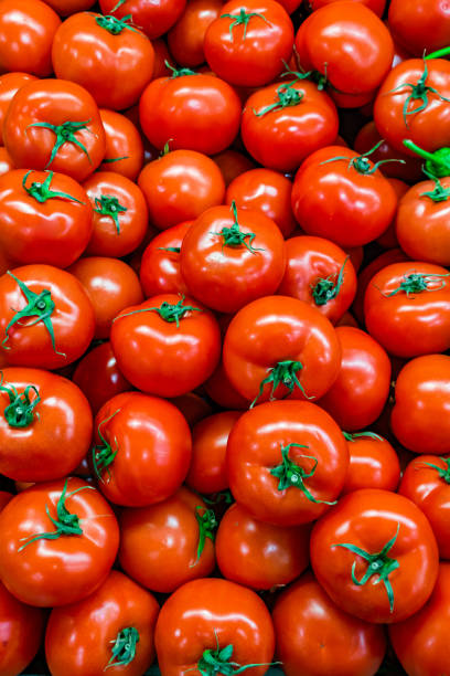 istock red tomatoes in bulk on market 2205685234