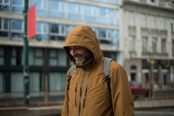 istock Cheerful young man enjoying walk in city 2205687072