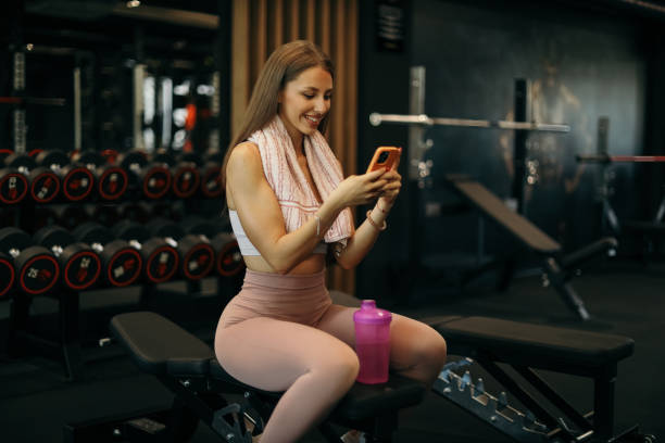 istock Woman on Phone During Gym Break 2205691003