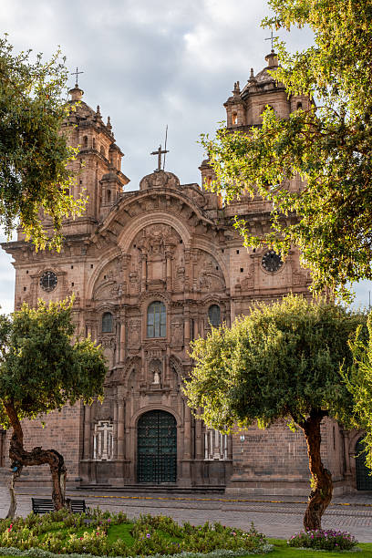 istock Historic Baroque Cathedral Framed by Lush Greenery in a Tranquil Square 2205693377