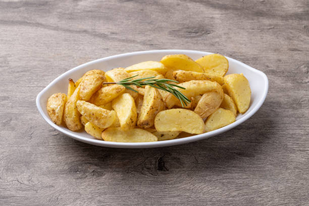 istock Rustic baked potatoes in a plate over wooden table 2205693673