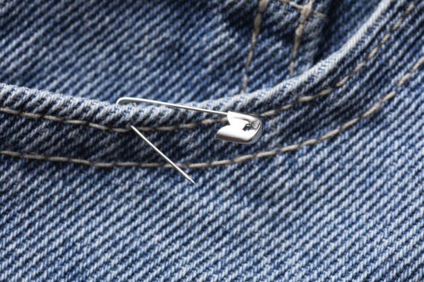 istock Metal pin on a blue jeans 2205694666