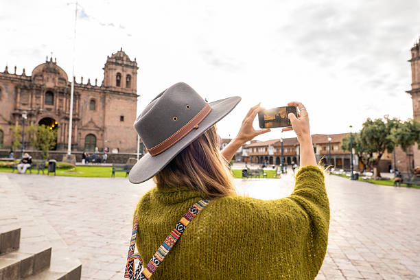 istock Tourist Capturing Historic Architecture in Sunlit Plaza 2205694845