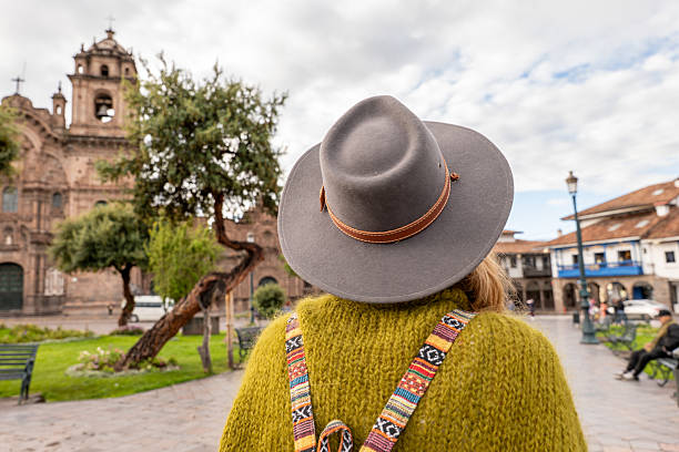 istock Woman exploring historic plaza with church backdrop 2205694998