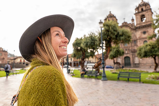 istock Woman exploring historic plaza with church backdrop 2205695001