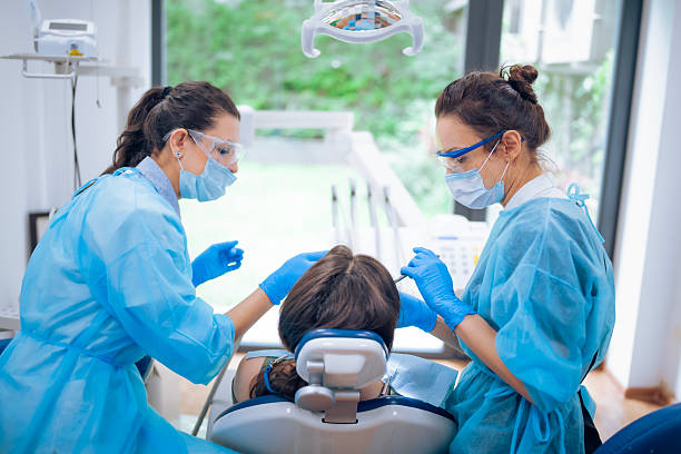 istock Female dentist examining a young patient's teeth. 2205696138
