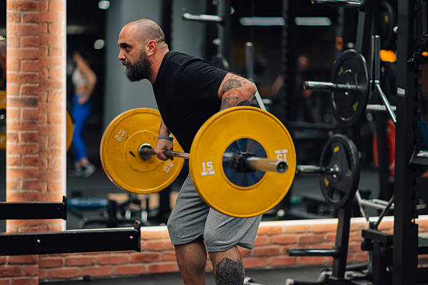 istock Determined male athlete lifting weights in gym, showing strength and dedication 2205698513