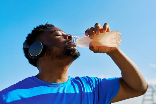 istock Young athlete drinking an energy drink after training 2205698620