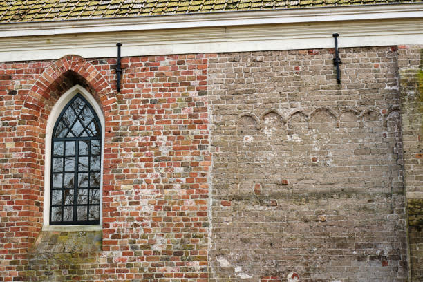 istock Historic church with graveyard and trees in Brantgum, Netherlands 2205700444