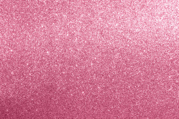 istock Pink glitter textured background with sparkling and shimmering effects under light 2205702089