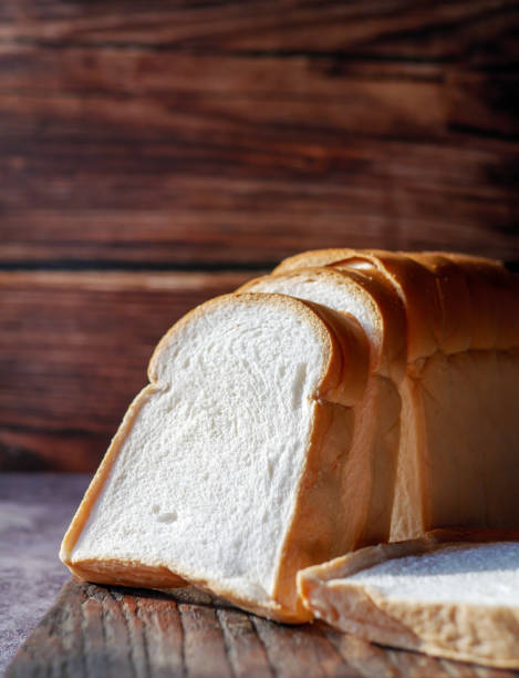 istock A stack of  white bread slices against Bread Sliced on Wooden Cutting Board 2205702251