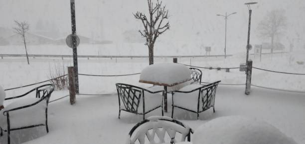 istock Snow on outside furniture terras 2205703100