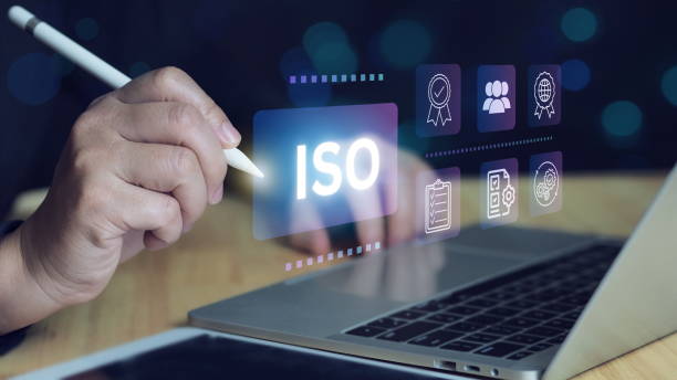 istock ISO certification and quality management concept. Business professional reviewing ISO certification standards with digital icons representing quality control 2205703426