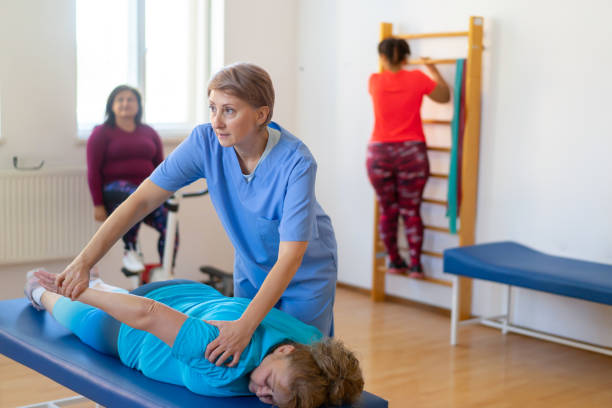 istock Therapist helping patient with leg stretching 2205703809