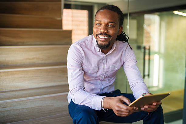 istock African man using digital device, tablet for online communication, education, work or social media 2205704497