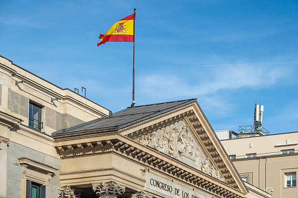istock A vibrant Spanish flag is prominently flying atop a tall building 2205705654