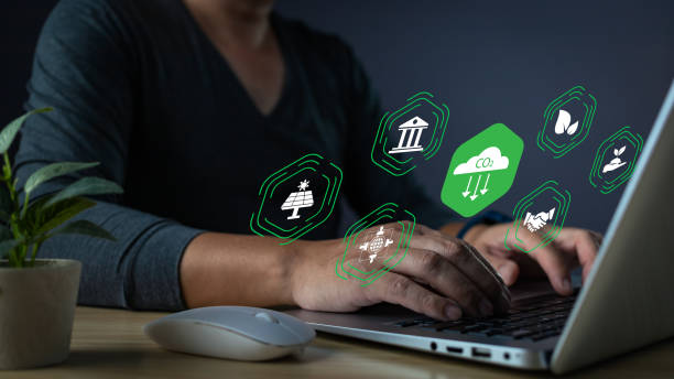 istock Working towards sustainability. Laptop users are surrounded by environmental icons, highlighting efforts to reduce CO2 emissions and promote green initiatives. 2205709020
