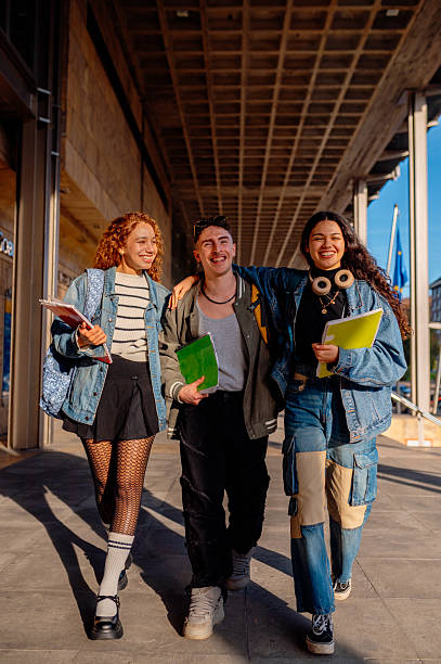 istock University students walking and talking together on campus 2205710312