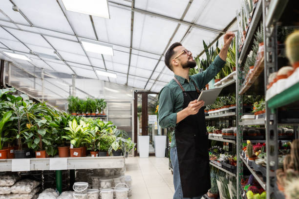 istock Gardener Organizing Lush Greenery with Care 2205711795