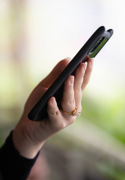 istock Young woman is typing message on mobile phone. 2205713753