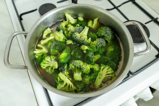istock Chopped broccoli is cooking on the gas stove. 2205714133