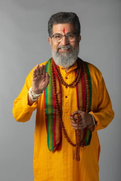 istock Old priest with rudraksha posing on white background 2205715639
