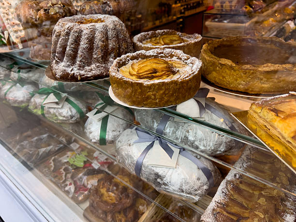 An assortment of freshly prepared pastries and desserts is on display in a Parisian patisserie. The image showcases a variety of sweet treats for customers to buy. Located in Paris, France.