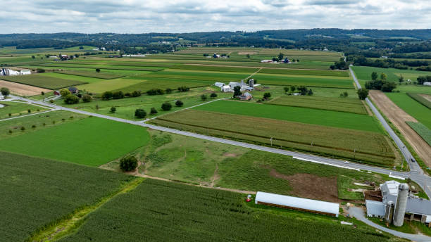 istock Expansive Farmland With Fields, Silos, and Rural Landscape Under a Cloudy Sky 2205717338