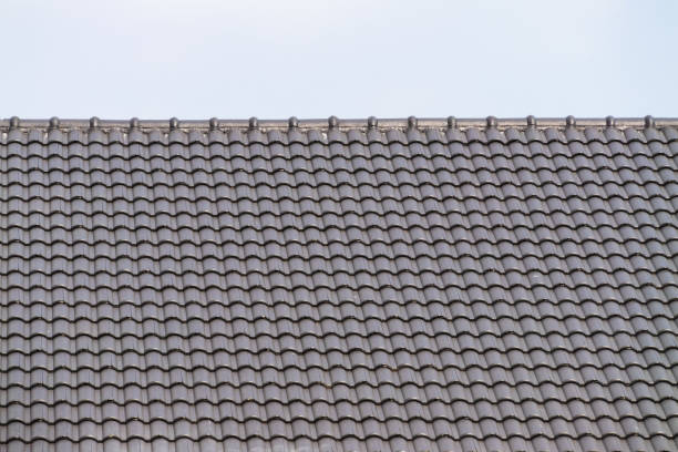 istock Urban construction imagery roofing installation process and building maintenance under clear skies 2205717473