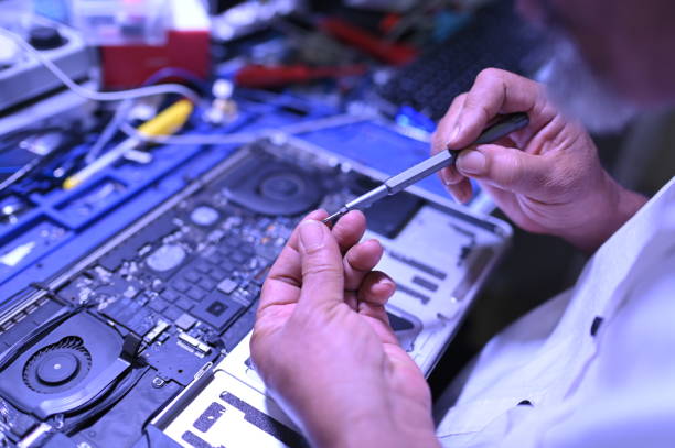 istock Close Up Technician is repairing a laptop 2205718809