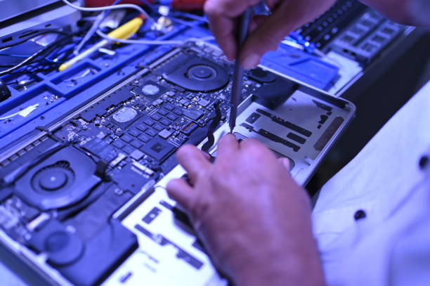 istock Close Up Technician is repairing a laptop 2205718810