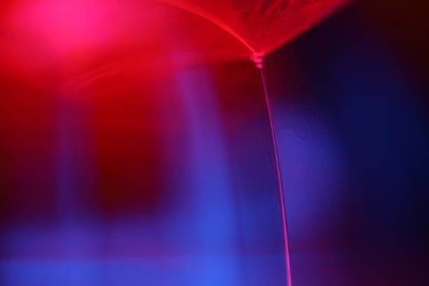 istock Red and purple liquid reflections on dark background, futuristic abstractions 2205720097