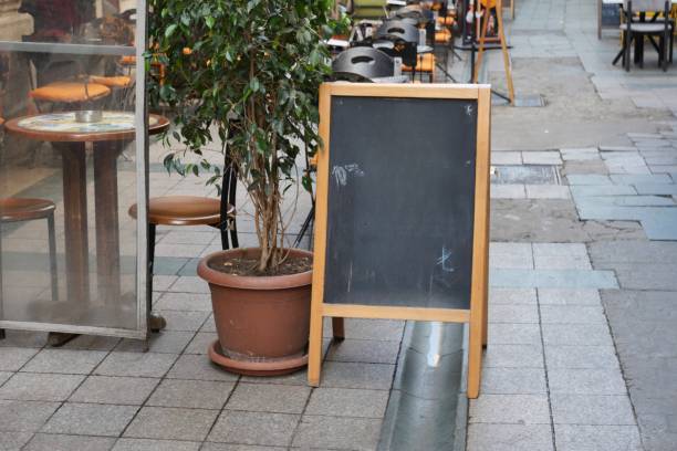 istock Chalkboard Sign Outside a Caf in a Charming Street View 2205721557