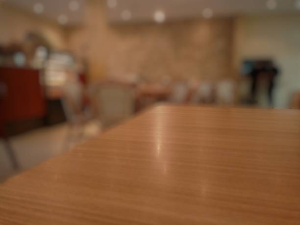 istock Empty wooden chairs and tables with a blurred restaurant background 2205721632
