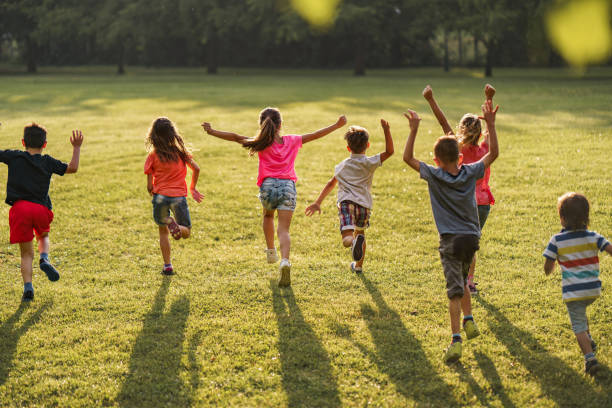 istock Children run across the meadow with outstretched arms 2205723933